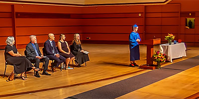Loki Anfinson speaking at graduation.