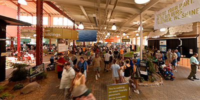 In front of the Eco House inside the Progress Center at the MN State Fair